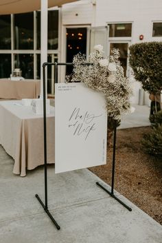 a sign that says mr and mrs on it in front of a table with flowers