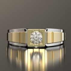 a gold and silver ring with a diamond in the center, on a reflective surface