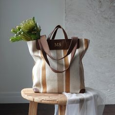 Striped Canvas Tote Bag with Monogram  Enhance your style with this elegant and versatile striped canvas tote bag. Featuring a timeless design with mustard and brown stripes, this tote bag is perfect for every occasion, from a casual day out to a beach trip. The monogram can be any name/initials you like,  adds a personalized touch, making it a unique addition to your accessory collection. Material: High-quality thick fabric with PU leather . Size: Please see picture. Everyday Striped Bags With Leather Handles, Brown Travel Bag With Striped Lining, Striped Bag With Leather Handles For Everyday Use, Beige Tote Shoulder Bag With Striped Lining, Striped Canvas Shopping Bag, Shopping Bag With Striped Lining And Double Handle, Canvas Bags With Striped Lining For Daily Use, Canvas Bags With Striped Lining For Everyday Use, Canvas Tote Bag With Striped Lining