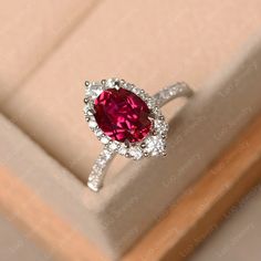 This ring features a 7*9 mm oval cut ruby. Customization is available. It is made by hand, and it will take about 7 days to finish the ring after your payment is completed.  Main stone: 7*9mm oval cut lab ruby  Main stone weight:2.32 ct  Metal type: sterling silver finished with rhodium/14k gold Accent stone: cz   Customization is available, I also can make it with 14k solid gold (white or yellow or rose) and diamond accent stone, just feel free to contact me. Any question, just let me know. :) My shop homepage: https://www.etsy.com/shop/LuoJewelry?ref=l2-shopheader-name Luo Jewelry, Rubin Ring, Gemstone Engagement Ring, Red Stone Ring, Pear Cut Engagement Rings, 14k Gold Engagement Ring, Oval Cut Engagement Ring, Emerald Ring Gold, Ruby Engagement Ring