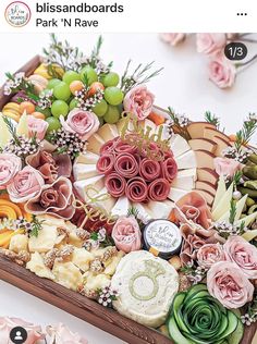 a wooden tray filled with lots of different types of flowers and succulents