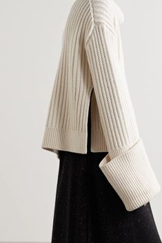 The Row's chunky 'Aneke' sweater has been rib-knitted in Italy from soft, cozy wool. Designed for an oversized fit emphasized by deep side slits, it has an enveloping turtleneck and exaggerated turned-up cuffs. Wear yours with skirts and jeans alike. Wear it with: The Row Skirt, The Row Tote, The Row Ankle boots. Chic Cashmere Chunky Knit Sweater, Chic Chunky Knit Cashmere Sweater, Chic Cashmere Ribbed Sweater, Oversized Cozy Turtleneck With Ribbed Collar, Chic Ribbed Cashmere Sweater, Oversized Wool Sweater With Funnel Neck, Chic Knit Turtleneck With Ribbed Cuffs, Chic Ribbed Sweater With Funnel Neck, Chic Ribbed Funnel Neck Sweater