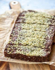 a close up of a piece of food on a wooden cutting board with wax and sprinkles