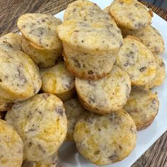 a pile of muffins sitting on top of a white plate