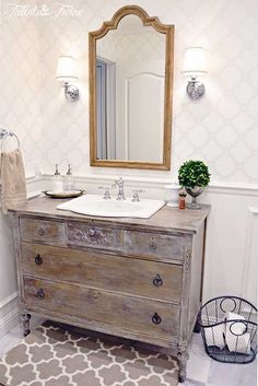 a bathroom with a sink, mirror and rug