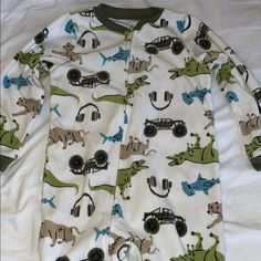 Carter’s Size 7 Excellent, New Condition Washed Once, Never Used 100% Polyester Footless Zip Up Plush Pajamas Cozy Pajamas With Fun Animal And Vehicle Prints. Zipper Front For Easy Wear. Dinosaurs, Headphones And Trucks White With Green Pajamas Cozy, Cozy Pajamas, Pajama Sets, Easy Wear, Dinosaurs, Pajamas, Size 7, Trucks, Zipper