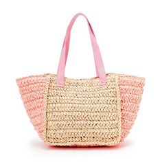 a straw bag with pink handles on the front and bottom, sitting against a white background