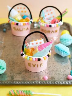 small baskets filled with candy and candies on top of a tray