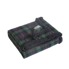 a green and black plaid blanket on a white background