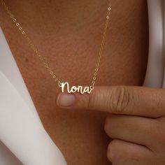 Escape to the Amalfi coast with our beautiful Amalfi Name Necklace! Its delicate design will turn heads and inspire confidence - making you feel like you can conquer anything! NECKLACE FEATURES Choice of 18k gold plating over sterling silver or Sterling Silver handcrafted custom name pendant (approx.* 1", up to 10 characters) Choice of Metal: Gold Fill or Sterling Silver Choice of Chain Style: Cable Chain or Upgraded Specialty Link Chain All necklace findings are gold filled/sterling silver. Eac Personalized Name Chain Necklace As Gift, Everyday Gold Name Necklace, Gold Name Necklace For Everyday Wear, Delicate Pendant Name Necklace, Personalized Necklace For Everyday Wear, Personalized Custom Necklace For Everyday, Everyday Personalized Custom Necklace, Minimalist Charm Necklace 16 Inch, Minimalist Name Necklace As Gift For Her