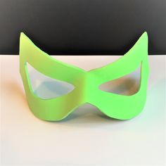 a green mask sitting on top of a table