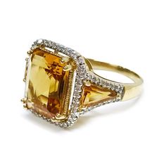 For Sale on 1stDibs - 14 Karat Citrine Diamond Ring. The ring features a 12 x 10mm square prong-set step-cut golden color Citrine and two triangle baguette citrines with a halo Formal Gold Topaz Ring With Gemstone Accents, Formal Yellow Topaz Ring With Diamond Accents, Luxury Trillion Cut Gold Rings, Luxury Gold Trillion Cut Rings, Formal Yellow Rings With Gemstone Accents, Yellow Rings With Gemstone Accents For Formal Occasions, Luxury Yellow Gold Octagon Topaz Ring, Formal Trillion Cut Topaz Ring In Fine Jewelry Style, Luxury Rectangular Topaz Ring For Formal Occasions