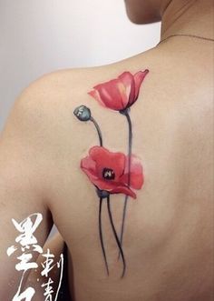 a woman's back with red flowers painted on it