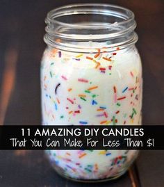 a glass jar filled with sprinkles on top of a wooden table next to a