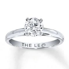 a diamond engagement ring with the word'the lee'engraved in white gold on it