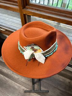 Discover the rugged charm of our Burned Western Hat. This unique, handcrafted cowboy hat features a distressed look, giving it a vintage, well-worn appeal perfect for Western enthusiasts and fashion-forward individuals. Features: Handcrafted Design: Each hat is meticulously burned and distressed to achieve a one-of-a-kind look. Premium Materials: Made from high-quality materials for durability and comfort. Unique Aesthetic: The burned finish adds a distinctive vintage style that sets it apart. B Vintage Handmade Hats For Ranch, Handmade Vintage Hats For Ranch, Distressed Brown Wide Brim Hat For Rodeo, Distressed Brown Wide Brim Hat For Country Events, Wide Brim Distressed Brown Hat For Country Events, Southwestern Style Brown Fedora Hat, Southwestern Brown Fedora Hat, Handmade Western Fedora For Western-themed Events, Handmade Southwestern Hats For Ranch