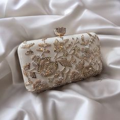 Elegant Cream Bridal Accessories, White Hand Embellished Clutch For Party, Gold Embellished Bridal Accessories For Wedding, Cream Bridal Accessories For Formal Occasions, Luxury White Clutch For Reception, Festive White Rectangular Clutch, Elegant Wedding Ring With Intricate Design, Elegant Gold Bridal Accessories With Intricate Design, Elegant Bridal Accessories With Intricate Design For Wedding