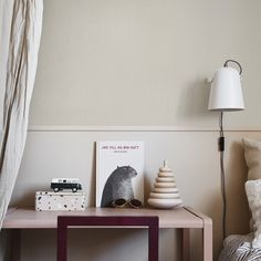 a small table with a lamp and pictures on it