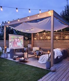 an outdoor living area is lit up with string lights