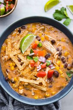 a blue bowl filled with chicken tortilla soup