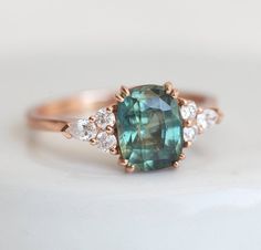 Teal Green Blue Sapphire Ring in Rose Gold 2.03 Cushion Cut | Etsy Green Sapphire Ring With Center Stone, Green Sapphire Ring With Gemstone Accents For Wedding, Green Cushion Cut Emerald Ring With Accent Stones, Cushion Cut Wedding Rings, Real Engagement Rings, Brown Diamond Ring, Cushion Cut Engagement, Titanium Wedding Band, Fancy Rings