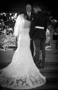 a bride and groom standing together in front of a gazebo at their wedding ceremony