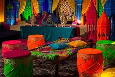 brightly colored tables and stools in an elaborately decorated room