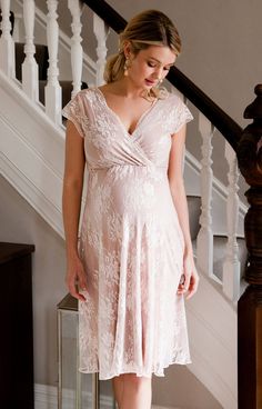 Warming blush is a radiant new colour for our Eden short maternity gown. Our new flattering nude shade suits any skin tone with a subtle air of vintage starlet. Layers of blush floral lace rest over premium softest UK made jersey with just a hint of added sheen. The flattering cross over neckline is gently gathered, finished with heavenly floaty capped sleeves. Add our tonal satin sash (not included) or extra sparkle with our divine twinkling jewelled sash (not included). Short Maternity Gown, Elegant Maternity Dress With Lace Bodice, Elegant Blush Lace Dress, Fitted Cream Maternity Dress For Wedding, Elegant Maternity Lace Dress, Elegant Maternity Dress In Cream, Fitted Lace Maternity Dress For Wedding, Elegant Cream Maternity Dress, Elegant Pink Maternity Dress