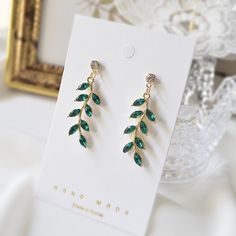 Dainty Emerald green leaf earrings. ♥ Material - Gold or Rhodium (White gold) plated over brass and Glass stone ♥ Earring total length - 38 mm (app. 1.5 inches) ♥ Stone Measurement - H. 30mm x W. 10mm  ♥ All the jewelry comes with gift wrap ♥ Please check the shop policy before you buy the products. Green Stone Earrings, Earrings Bridesmaid, Bridesmaid Necklace, Emerald Earrings, Green Leaf, Bridesmaid Earrings, Earrings Sterling Silver, Sterling Silver Studs, Green Stone