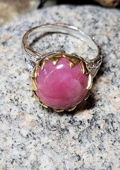 This ring is old store stock- unworn. It is top quality vintage pink genuine ruby. It is sterling silver which is plated with white and yellow gold. This means it won't tarnish. The ruby is 5/8 of an inch or 12mm around. It retailed at $102 and comes in a tiny ring box. Pink Round Cabochon Ruby Ring, Pink Cabochon Ruby Ring, White Gold Cabochon Sapphire Ring Gift, Pink Round Heirloom Jewelry, Pink Ring With Polished Finish, Fine Jewelry Pink Cabochon Ring, Heirloom Gift Sapphire Ring With Cabochon, Heirloom Sapphire Cabochon Ring As Gift, Pink Cabochon Jewelry For Anniversary