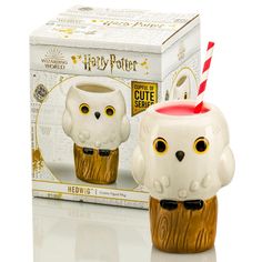 a harry potter mug with an owl on it's head and a straw in its mouth