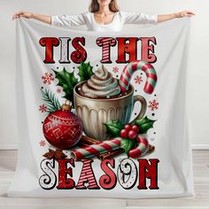 a woman is holding up a christmas themed banner with the words tis the season on it