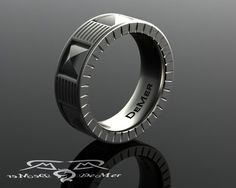 a black and silver ring with the word david written on it's side, in front of a dark background