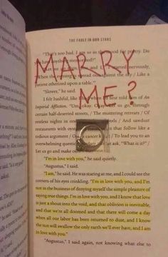 an open book with the words marry me? written on it