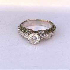 an antique style diamond ring with filigree band