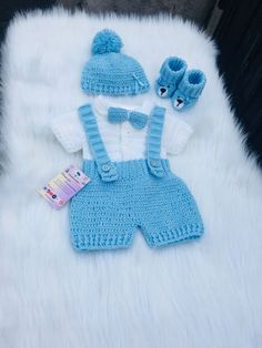 a blue knitted outfit and matching hat for a baby