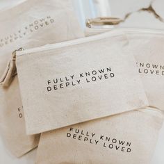 three zippered pouches with words written on them