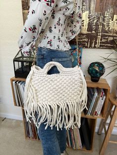 "Check out our Bohemian Fringe Crochet Bag.  This Large White Boho handwoven is the perfect addition to your wardrobe. This bag is very versatile and sophisticated enough for a day at the office or a night out yet casual enough for downtime. The bags are very comfortable and can be used as a crossbody or over the shoulder.  This handbag is the accessory you need to complete your look and a fantastic gift for someone you love.  This bag is 100% hand knit. Color: White  Metal: Gold  Dimensions:  P Bohemian Macrame Shoulder Bag, Everyday Bohemian Macrame Shoulder Bag, Everyday White Macrame Bag, White Macrame Bag For Everyday Use, Everyday Bohemian Macrame Bags, Bohemian Everyday Bags With Macrame, Bohemian Crochet Shoulder Bag With Braided Handles, White Bohemian Crochet Bag With Braided Handles, Bohemian Satchel With Braided Handles