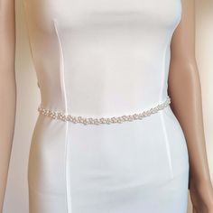 "This bridal belt is made entirely by hand with a multitude of pearl beads. A very elegant accessory that will add the perfect accent to any bridal or bridesmaid's dress. Wired on copper wire, it is very flexible and will easily fit around your waist.  The belt can be laced on the back with double-sided satin ribbon.   original Happy Wedding Dreams model handmade in my workshop in France (Meuse) * flexible for a perfect fit * modifiable and customizable according to stock availability * production time 3-5 working days DIMENSIONS:  decorative part: length 40 cm (15.7\") or 60 cm (23.6\");  width 1.2 cm (0.47\")   satin ribbon: width 0.6 cm (1/4\") total length: 200 cm (78.7\") *Due to the entirely manual process, dimensions may vary slightly - 1 cm)!  COLOUR OPTION: This accessory comes wi Belt Wedding Dress, Bridal Sash Belt, Wedding Dress Belt, Wedding Sash Belt, Bridal Hair Clip, Bridal Sash, Wedding Belts, Pearl Bridal, Bridal Belt