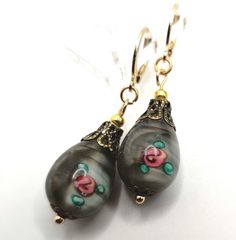 Vintage Olive and Rose Millefori Glass Earrings are hand made by me. The teardrop shape bead has beautiful roses inlaid with antique brass tone filigree caps on gold piercing latch. They are the perfect gift for mother's day, birthday or anniversary and Christmas gift. handmade jewelry gift. gift for her. Valentine's Day gift Handmade Ornate Teardrop Earrings, Handmade Czech Glass Teardrop Earrings As Gift, Handmade Czech Glass Teardrop Earrings For Gift, Nickel-free Czech Glass Teardrop Earrings As Gift, Christmas Gift Handmade, Bead Earring, Belle Rose, Earrings Christmas, Handmade Jewelry Gift