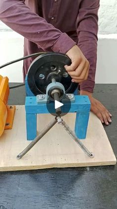 a man is working with a machine on a table