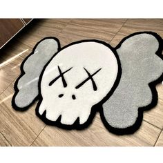 a rug with a skull and angel wings on it