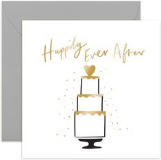 a card with the words happily ever after on it and a gold heart sitting on top of a cake