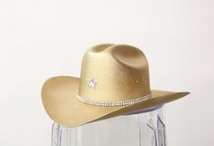 YEEHAW! Our most popular blinged out Cowboy hats are here in perfect metallics! Want it without crystal star? Write "NO STAR" in the notes section! Super limited quantities! Size chart S/M- Has elastic insert making it fit more snug- 24" around but fits 22-26" L/XL-Has elastic insert making it fit more snug- 28" around but fits 26-30" This item is made to order in our Costa Mesa Studio! Gold Cowboy Hat, Crystal Stars, Gold Sequin, Cowboy Hat, Eras Tour, Cowboy Hats, Most Popular, Cowboy, Outfit Ideas