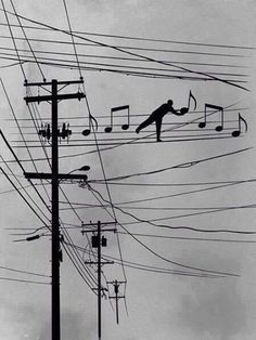 an image of a person jumping in the air with music notes on wires behind them