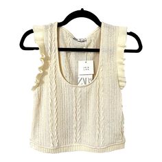 - Sleeveless With Trendy Ruffle Trim - Ivory/Cream Color - Cable Knit - Size Large (Runs A Little Small) - Pit To Pit 16" Across Stretches To 17.5" - Length 18" - 100% Polyester - Nwt White Pointelle Knit Tank Top For Spring, Sleeveless Cable Knit Cotton Top, Chic Textured Knit Beige Sweater Vest, White Ruffled Knit Top For Spring, Chic Beige Textured Knit Sweater Vest, Chic White Knit Top With Ruffles, White Ruffled Knit Top For Summer, Chic Cotton Knit Top With Ruffles, White Textured Knit Sleeveless Sweater Vest