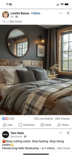 a bed room with a neatly made bed next to a window and a round mirror