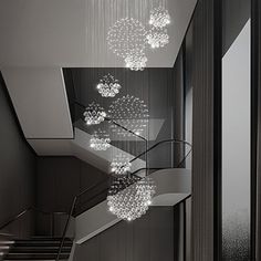 a staircase with chandeliers hanging from the ceiling