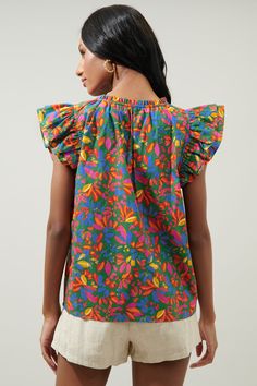 Spruce things up in this vibrant, tropical floral print. It works to shape the evergreen, Risette top. A flirty, lightweight blouse that features ruffled cap sleeves. They frame a split neckline and the top maintains a relaxed bodice that can be worn tucked in or out. Wear it with your favorite denim and fun sandals to compliment the look.- Lightweight- Split neckline- Cap sleeves- Relaxed fit- Color: Kelly MultiSize + Fit - Model is 5'10" and wearing size XS- Measurements taken from size S - Ch Multicolor Ruffle Sleeve Tops For Vacation, Multicolor Flutter Sleeve Tops For Beach, Multicolor Flutter Sleeve Tops For The Beach, Multicolor Ruffle Sleeve Tops For Beach, Vibrant Green Floral Print Blouse, Summer Multicolor Print Ruffled Tops, Vibrant Cotton Floral Print Top, Multicolor Floral Print Flutter Sleeve Tops, Multicolor Floral Print Top With Flutter Sleeves