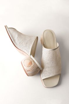 A neutral jute upper accented by a hand-sculpted, round heel made from Peruvian pine. 65 mm heel Jute and leather upper, leather lining and sole Heel made from sustainably sourced wood Responsibly handmade in Peru Runs true to size; half sizes or wide widths, order next size up. Whole sizes only. Natural Leather Open Heel Mules, Beige Mules With Wooden Block Heel, Natural Color Heels With Wooden Heel, Natural High Heels With Wooden Heel, High Heel Sandals With Removable Insole In Natural Color, Beach Heels With Wooden Heel In Natural Color, Natural Sandals With Wooden Heel, Natural High Heel Sandals With Removable Insole, Cream Mules With Wooden Heel For Summer